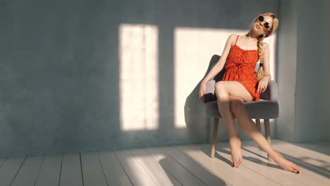 woman in red dress sitting in a chair