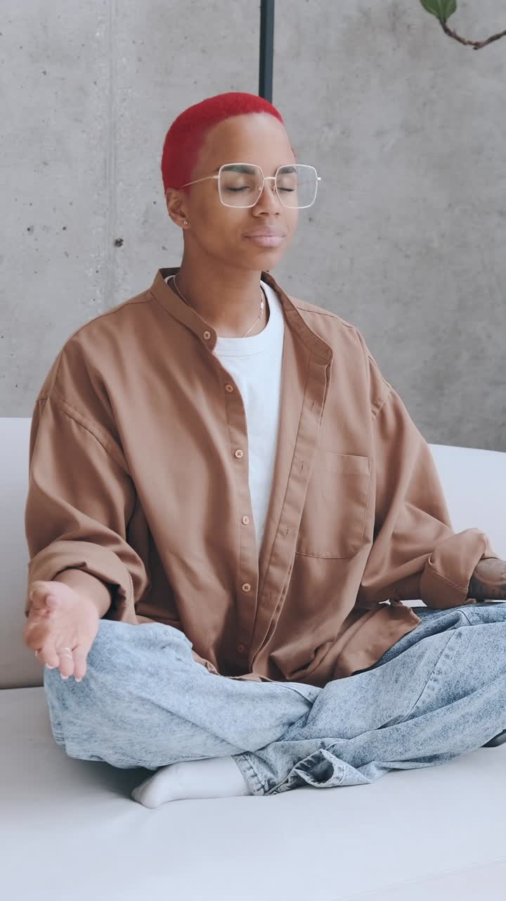 Person meditating in a modern indoor space with natural light during the day