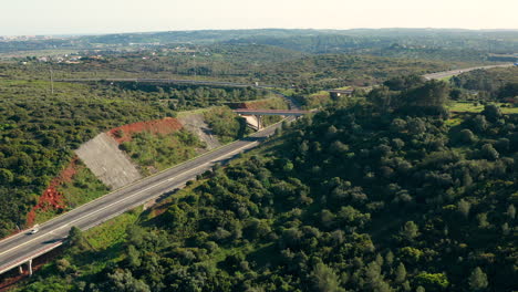 Aerial:-A-highway-going-through-the-country-side-of-the-Algarve-in-Portugal