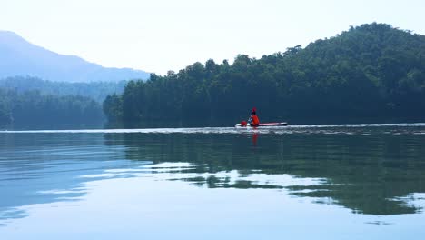 kayaker paddling peacefully on a serene lake