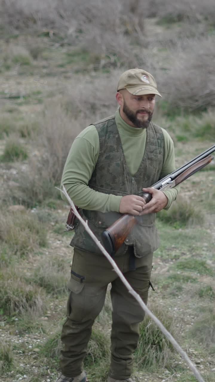 Hunter with rifle in field