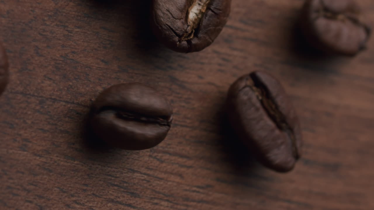 Detail shot of coffee beans on a wooden table