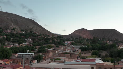 aerial - small town of tilcara in jujuy, argentina, wide lowering shot