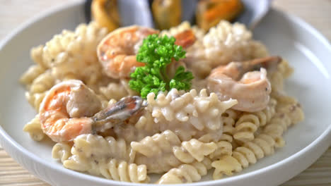 spiral pasta mushroom cream sauce with seafood - italian food style