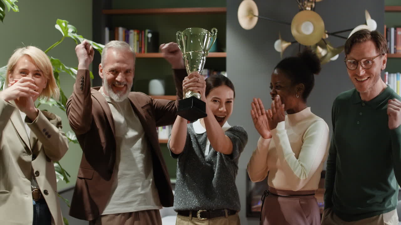 Diverse Business Team Celebrates Success with a Trophy