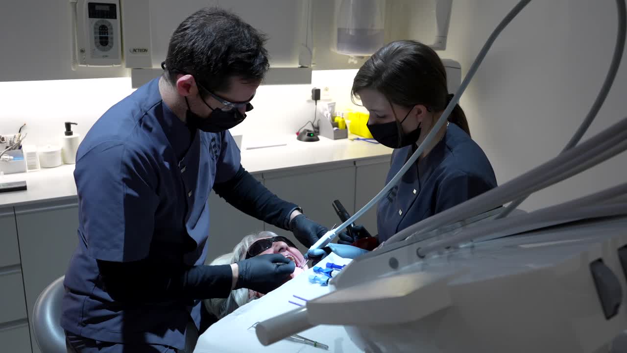 Dentists performing a dental procedure on a patient