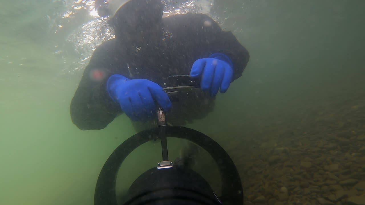 Underwater selfie as scooter pulls diver through strong river current
