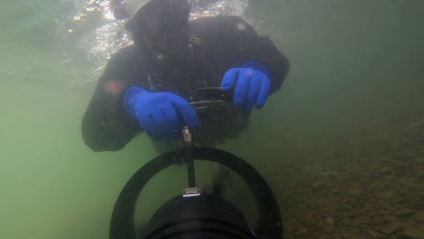 underwater selfie as scooter pulls diver through strong river current