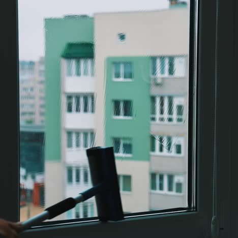 employee hand cleaning glass