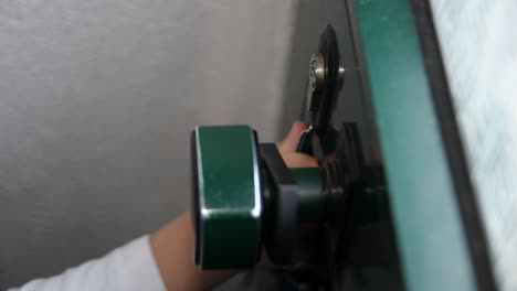 a young child trying to unlock and open a door with the key in the hand, twisting and turning the key until he finally manages to insert the key in the keyhole and unlock