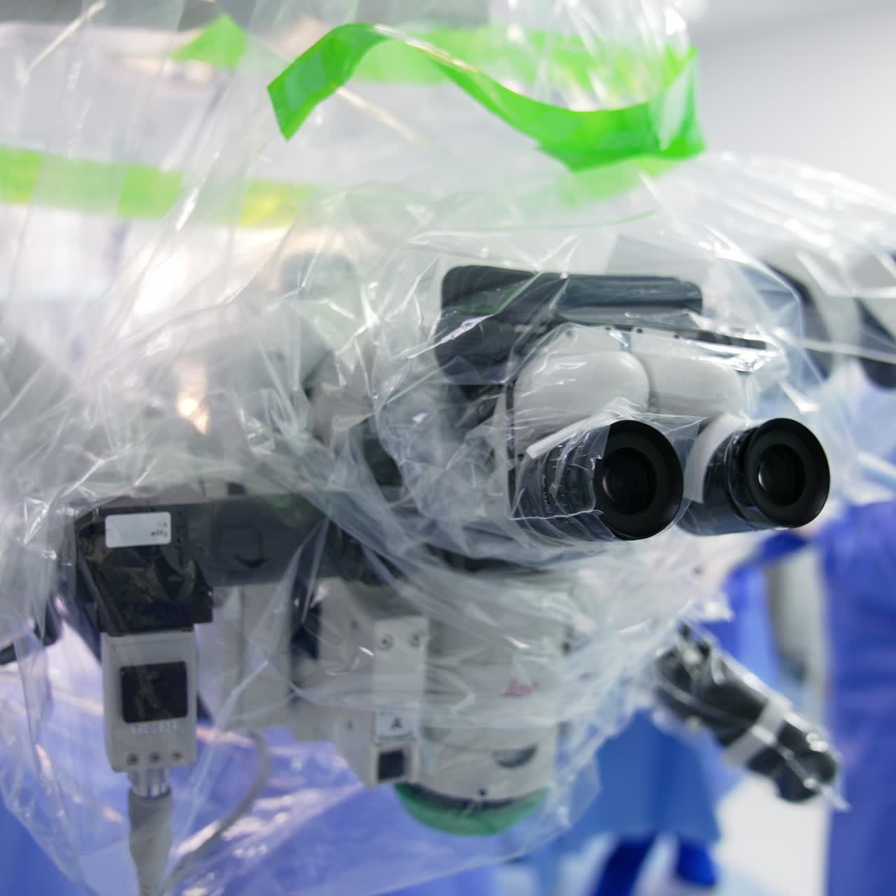 Looking at binoculars of powerful microscope coated in plastic. Close up. Advanced equipment prepared for operation