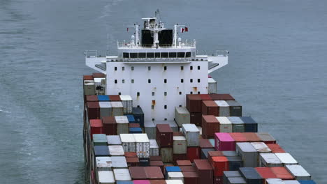 parallax panning view of a container vessel navigating at sea while radars turns