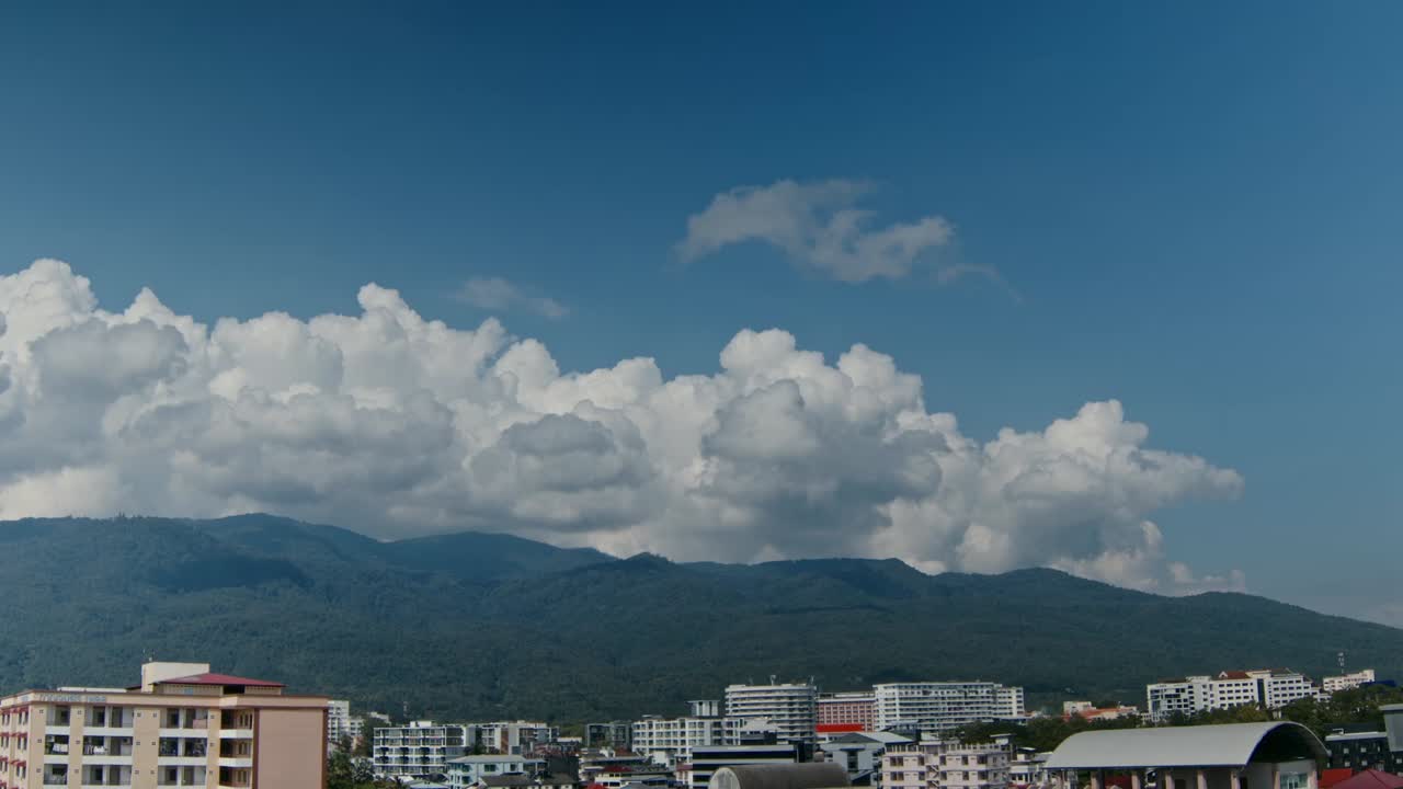 Cityscape View with Mountains and Clouds
