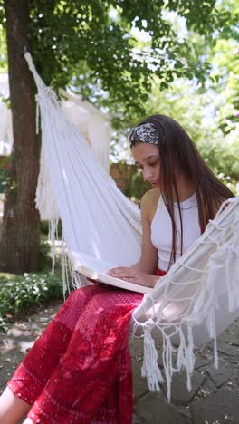 woman reading in a hammock