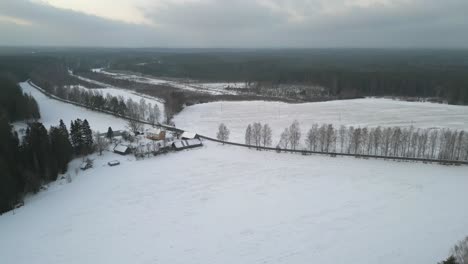 Aerial-view-of-frozen-rural-landscape-on-a-winter-day-in-Estonia,-Northern-Europe