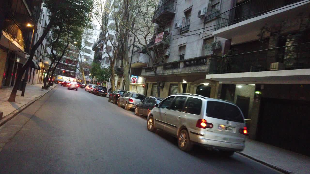 POV driving through small street of buenos aires city in recoleta neighborhood at sunset