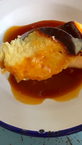 close up of caramel flan on spoon