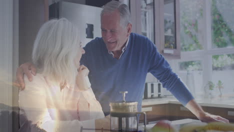 senior man placing hand on mature woman in kitchen, with floating health icons and coffee graphics