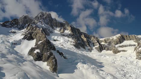 4K-drone-footage-flying-towards-huge-imposing-mountain-summit