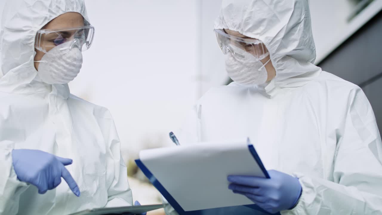 vídeo de dos técnicos que caminan con un documento y una tableta