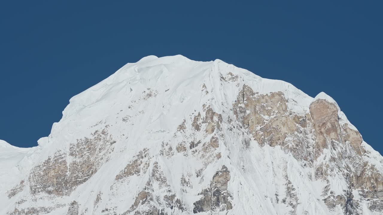 Snowy Mountain Top Close Up in Nepal with Clear Blue Sky, Snowcapped Winter Himalayas Mountains Scenery Covered in Snow in Nepal, Annapurna Mountain Range a Popular Hiking and Trekking Area