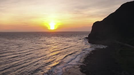 drone ascending shot showing reaching waves of pacific ocean at orchid island in taiwan