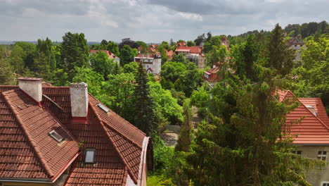 aerial view low over roofs of typical polish homes, sunny, summer day in poland