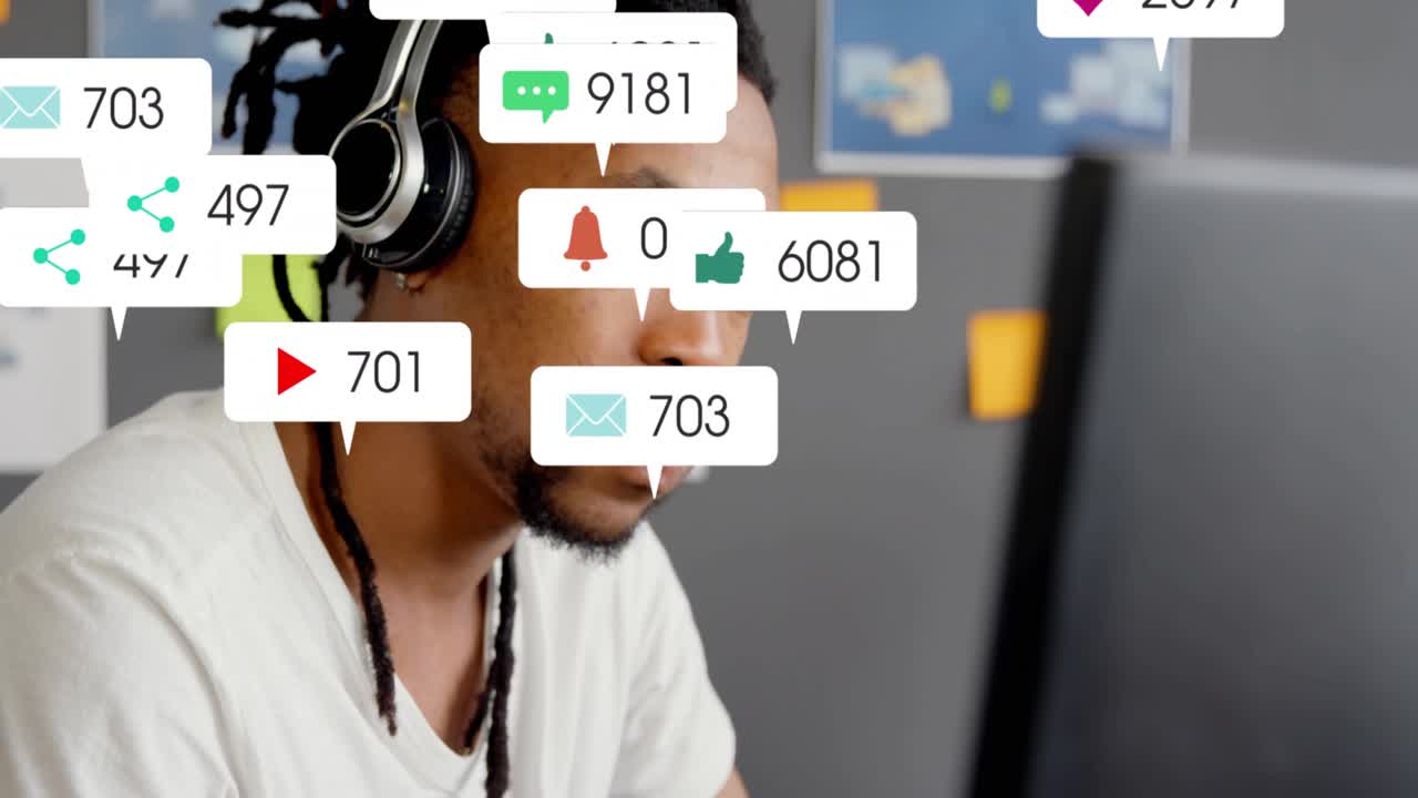 Man typing on keyboard at desk, social media badges multiplying and floating around head