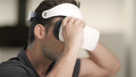 young man putting on video glasses. portrait of man sitting in video glasses.