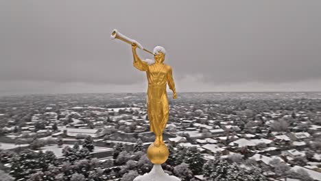 snow covered golden angel moroni on trumpet atop provo lds mormon temple