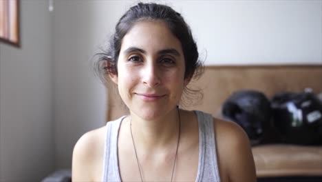 portrait of brunette natural woman smiling to camera