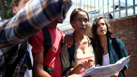 friends holding map and pointing