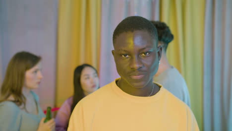 Portrait-of-a-confident-young-African-American-boy-looking-at-the-camera-and-drinking-beer-at-home