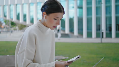 woman speaking webinar outdoors at laptop. businesswoman talking video meeting.