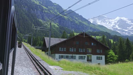 scenic train ride in the valley of alps mountain from the window with alps view, lauterbrunnen switzerland