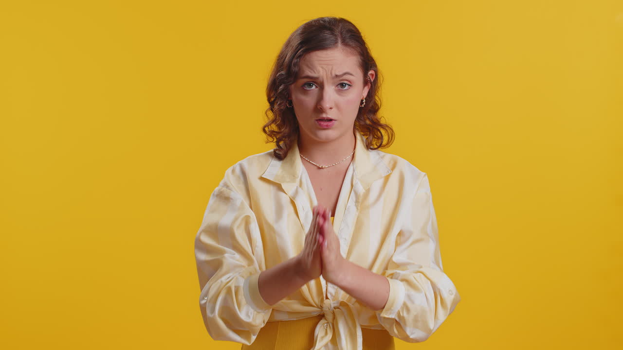 Attractive woman praying looking upward making wish begging apology asking help forgive me