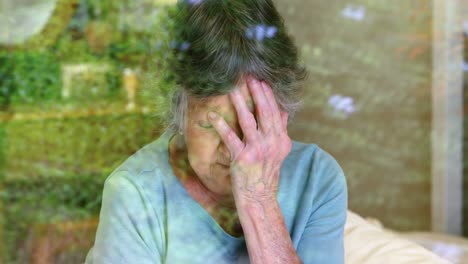 Worried-senior-woman-looking-through-the-window-4k