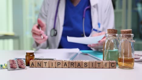 medical professional with antiparasitic medication and supplies