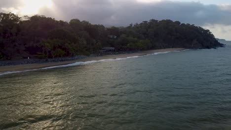 Aerial-Over-Waves-Breaking-On-Trinity-Beach-During-Sunset