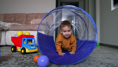 toddler crawling through a tunnel