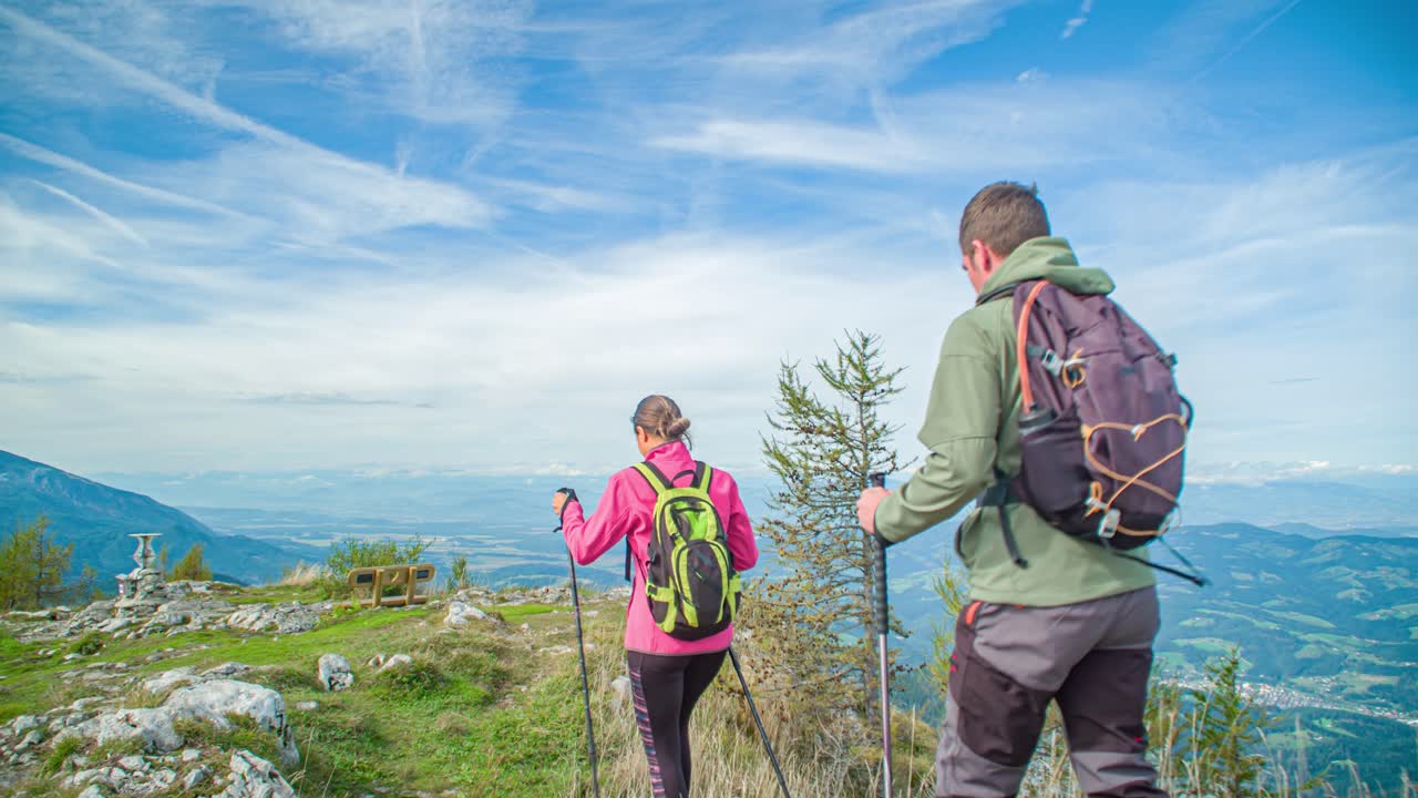 Couple of hikers walk on top of mountain near Urslja Gora in Slovenia
