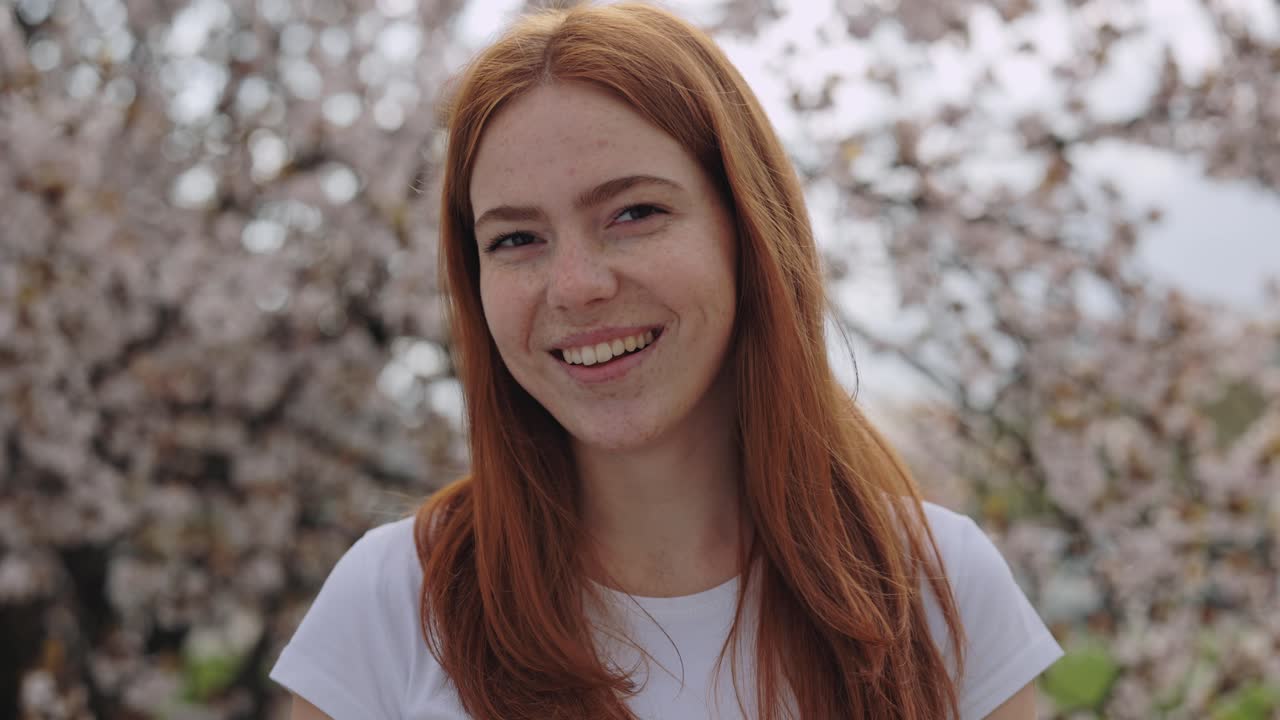 Smiling Woman in Cherry Blossom Trees
