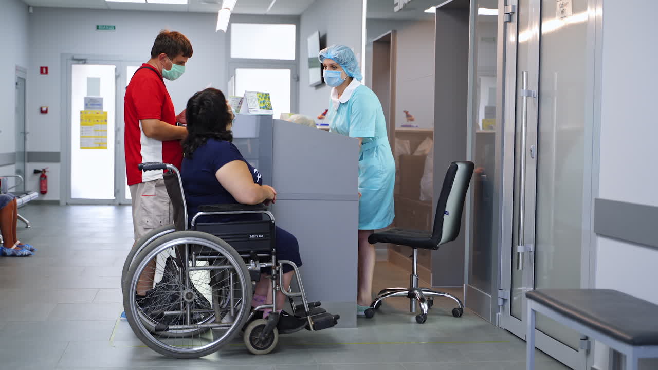 Hospital Reception with Patient in Wheelchair