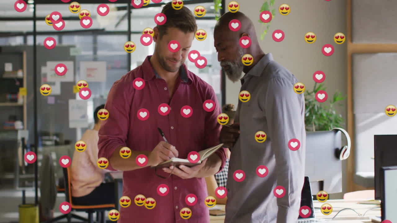Office team collaborating on technology strategy, with floating heart emoji and whiteboard charts