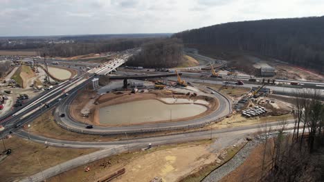 drone-construction-highway-wide-sun-and-clouds