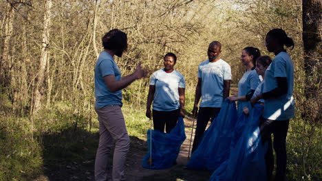 team of activists picking up plastic waste to recycle and collect rubbish