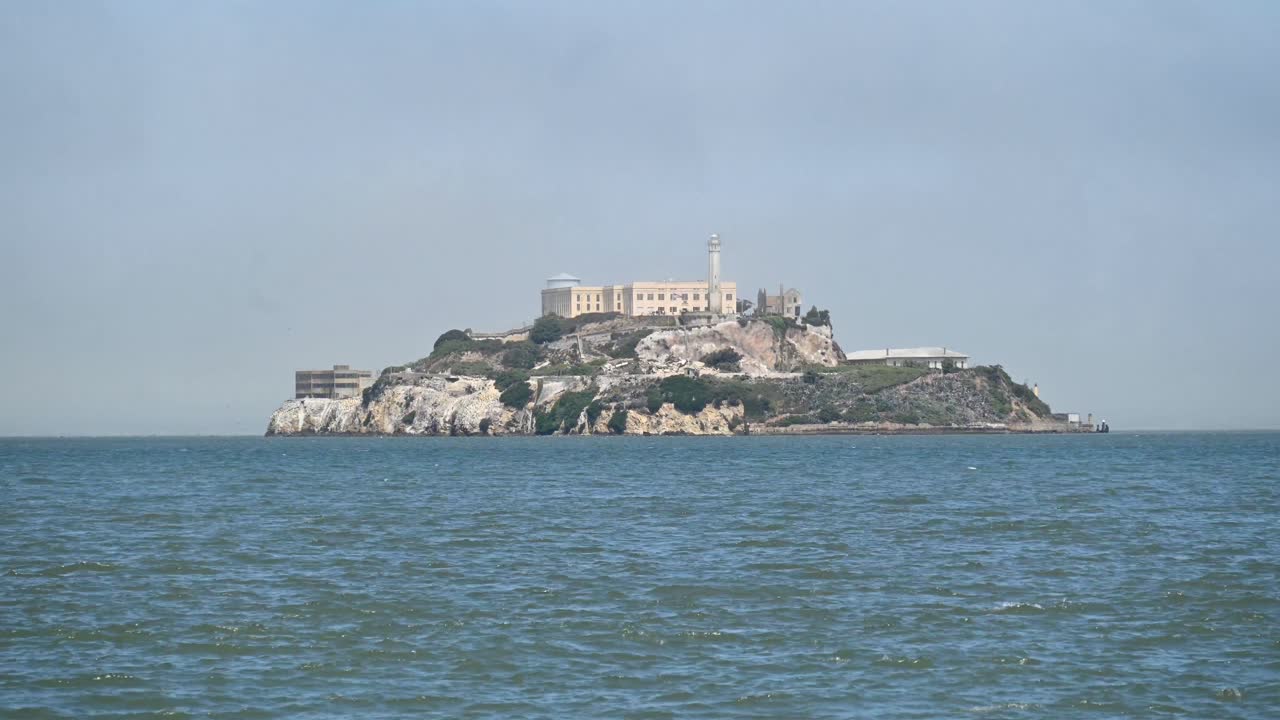 A Timelapse of the iconic Alcatraz with fog and boats and birds flying by, San Francisco California