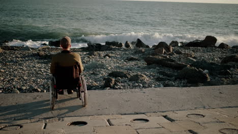 man in wheelchair at the beach