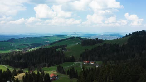 aerial-view-of-single-windmill-in-the-swiss-countryside-during-sunny-day,-renewable-energy-from-wind-power-turbines