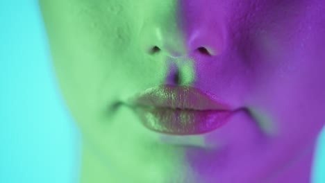 extreme close up shot of a beautiful woman's lip as she presses her lips together to spread her newly applied lipstick after getting ready for club night evenly in slow motion